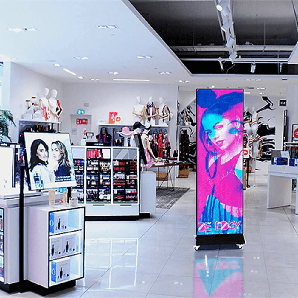 Vertical digital display screen showing a fashion advertisement in a retail store.