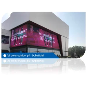 Large full color outdoor LED display on the exterior of Dubai Mall showing a promotional video.