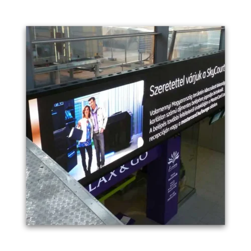 Large digital display screen showing a couple posing in front of a black object at SkyCourt.