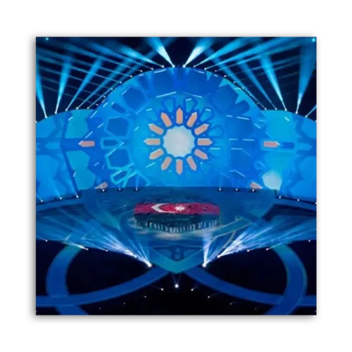 Stage design featuring blue lighting and a Turkish flag at the center.