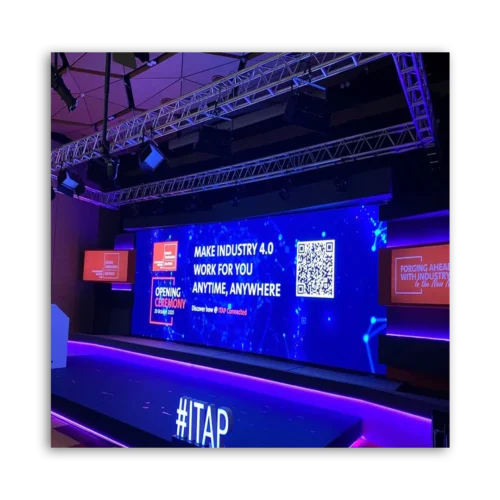 Large digital screen displaying text about Industry 4.0 at an event venue.