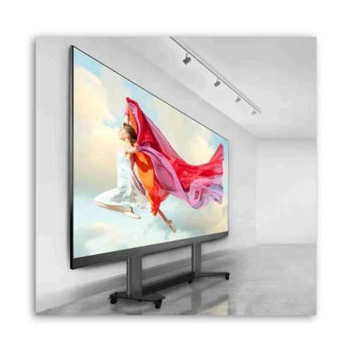 Large digital display featuring a woman in mid-air with flowing fabric in a bright setting.