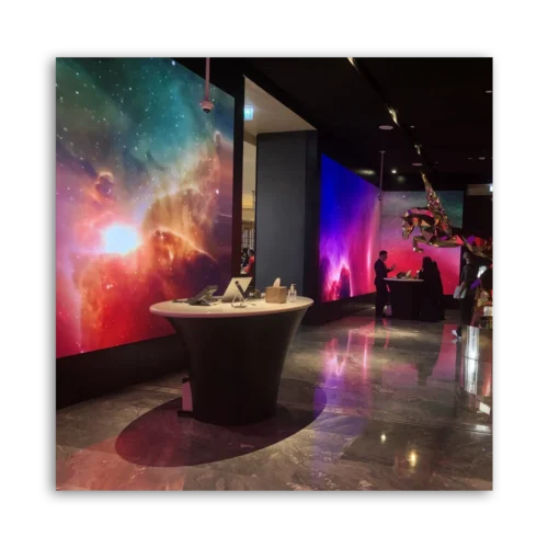 Interior view featuring colorful abstract wall art and a reception desk in a modern setting.